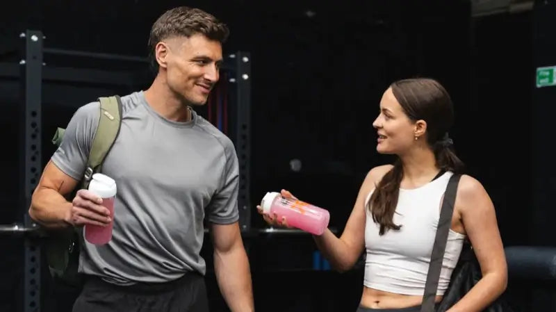 A fitness couple holding a bottle of MOVE